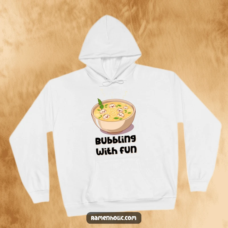 Funny hoodie featuring a plump bowl of broth bubbling with laughter and tiny swimming noodle characters, offering cozy cartoon comfort.