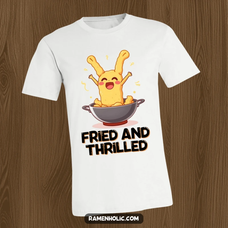 Funny tempura piece leaping out of a wok with a joyful, surprised expression, printed on a t-shirt.